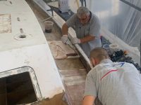 Gunwales are sanded and covered with fiberglass to act as an external skeleton