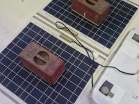 Day 181 - Solar plates are installed with sikaflex, for a tight fit heavy weights are applied